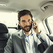 Man on phone in a comfy car 