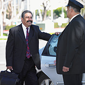 Chauffeur helping man into the car